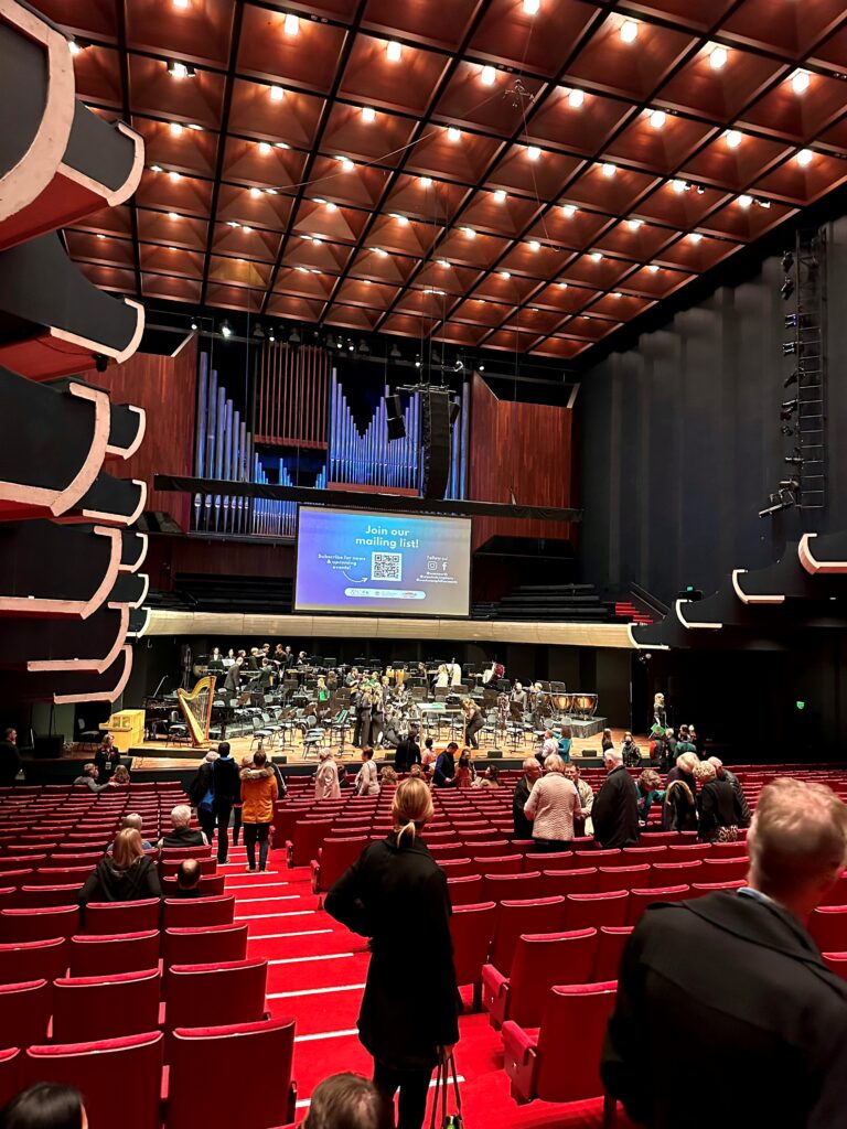 woman stands in audience of perth concert hall